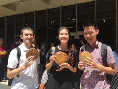 Project team holding big cookies