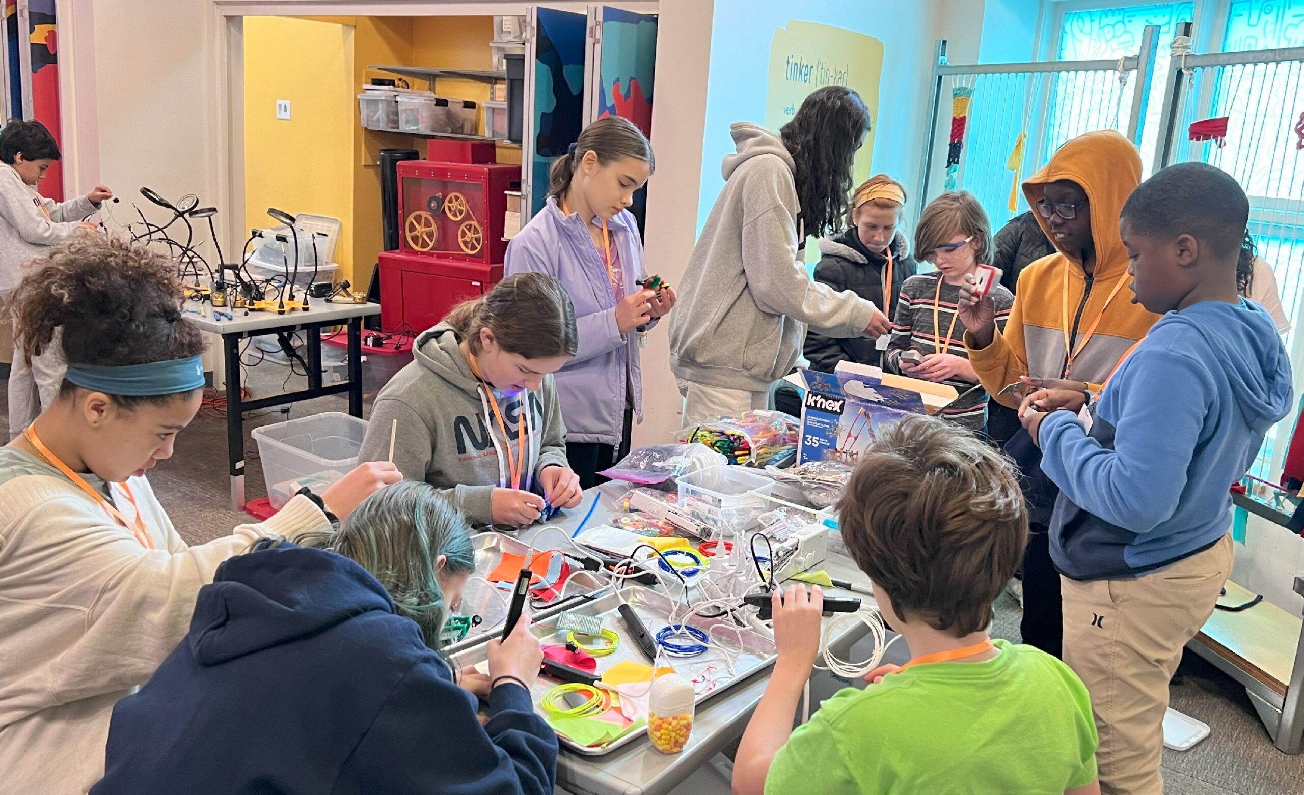 a group of young students works on stem puzzles at a table