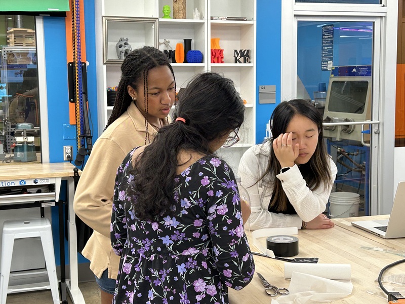 three students working at a table
